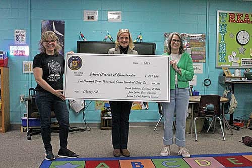 After Crescent Elementary School’s excited kindergartners returned to class following unforgettable fun with Wisconsin Secretary of State Sarah Godlewski on April 10, Godlewski (center) posed with grateful SDR library media specialists Ellie Rumney (left) and Paula Norman, along with the check representing SDR’s $207,766 Common School Fund Library Aid distribution share that will greatly benefit its libraries. (Photo by Ardith Carlton/River News)