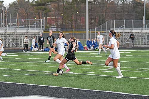 Karsyn Dyre gears up for a shot before scoring a goal with Northland Pines’ Addison Paez looking on in the first half of a conference game Tuesday, April 14 at IncredibleBankField in Minocqua. (Photo by Brett LaBore/Lakeland Times)