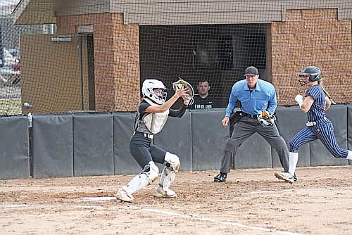 Lani Frisch, left, catches the ball before tagging out Tomahawk’s Kylie Peissig at home plate with umpire Paul Johnson looking on in the third inning of a conference game Tuesday, April 14 at Lenz Field in Minocqua.
(Photo by Brett LaBore/Lakeland Times)