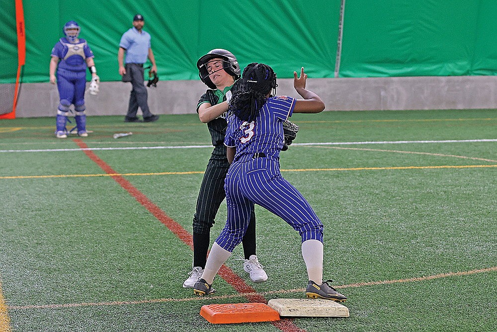 Rhinelander’s Maddie Paulson collides with Northland Pines first base person Olivia Asbury during the first inning of a GNC softball game against Northland Pines in the Hodag Dome Monday, April 13. (Bob Mainhardt for the River News)