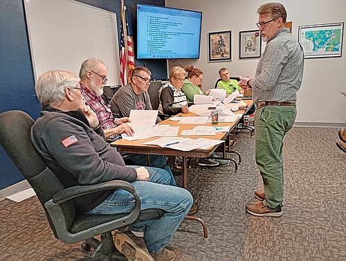 At their meeting April 15, the Pine Lake town board heard updated details from Town and Country Engineering’s Mark Barden, right, about the city of Rhinelander’s proposal to extend utilities to a site south of Shepard Lake Road. (Photo by Ardith Carlton/River News)