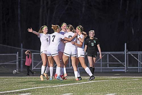 Thunderbirds from left, Malin Awker, Lexi Gindorff (7), Jaime Jorgensen, Karsyn Dyre (6) and Bella Peterson celebrate after Dyre’s penalty kick goal in the second half of a 1-0 win over Rhinelander Thursday, April 16 at Mike Webster Stadium in Rhinelander. (Photo by Brett LaBore/Lakeland Times)