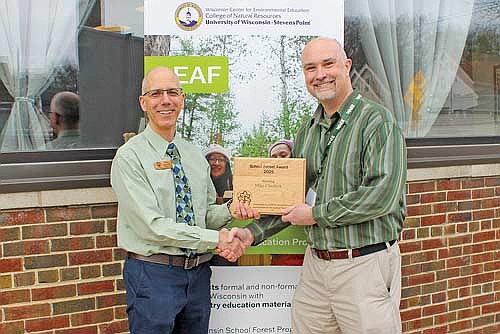 SDR School Forest Manager Mike Cheslock, right, was recently presented with the LEAF Program’s Wisconsin School Forest Award by Steve Schmidt of LEAF. (Contributed photograph)