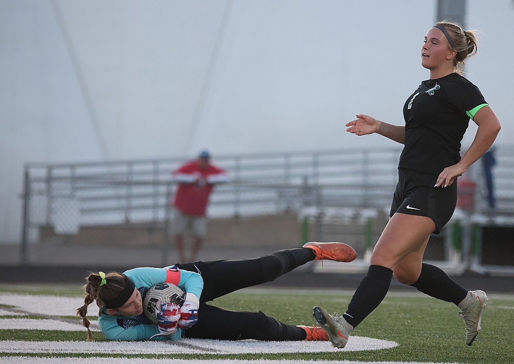 Lakeland goalkeeper Ava Evenhouse covers up a shot by Rhinelander’s Ella Miljevich during the first half of a GNC girls’ soccer game at Mike Webster Stadium Thursday, April 16. Despite outshooting Lakeland 21-4, the Hodags lost to the T-Birds, 1-0. (Blake Richard/River News)
