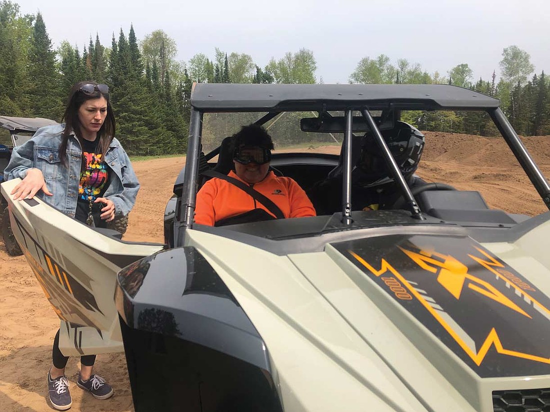 Breanna Semmerling, left, is excited to go on a ride in a UTV with Area 31 lead guide Chayce Walker, right. (Contributed photograph)