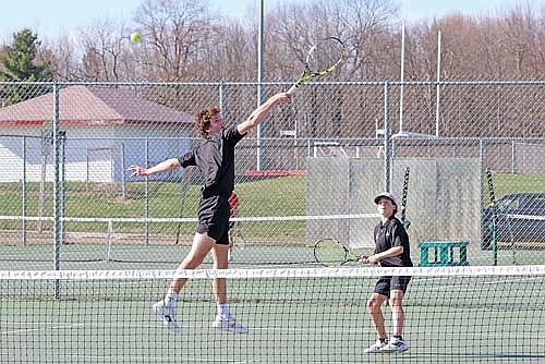 Andrew Colianni leaps for a backhanded shot at the net with Main Byram looking on in a conference match against Medford Tuesday, April 21 at the Medford Area Senior High School tennis courts. Colianni/Byram improved to 4-1 at No. 1 doubles this season. (Photo by Matt Frey/Star News)