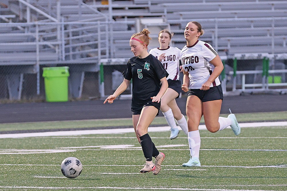 Rhinelander’s Jordan Manske races ahead of Antigo’s Annie Lundgren during the first half of a GNC girls’ soccer game at Mike Webster Stadium Thursday, April 23. (Bob Mainhardt for the River News)