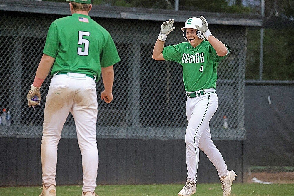 Rhinelander’s Josh Willoughby trots home where teammate Jackson Waydick (5) waits to celebrate after Willoughby hit a home run during a GNC baseball game against Lakeland Thursday, April 23 in Minocqua. The Hodags collected 20 hits in a 25-4 win. (Blake Richard/River News)