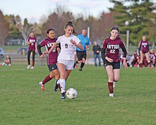 Bella Peterson dribbles the ball followed by Antigo’s Amaya Samolinski in a 9-1 win Tuesday, April 28 at Listle Field in Antigo. Peterson scored her first-career high school goal in the first half. (Photo by Antigo Sports Photography)