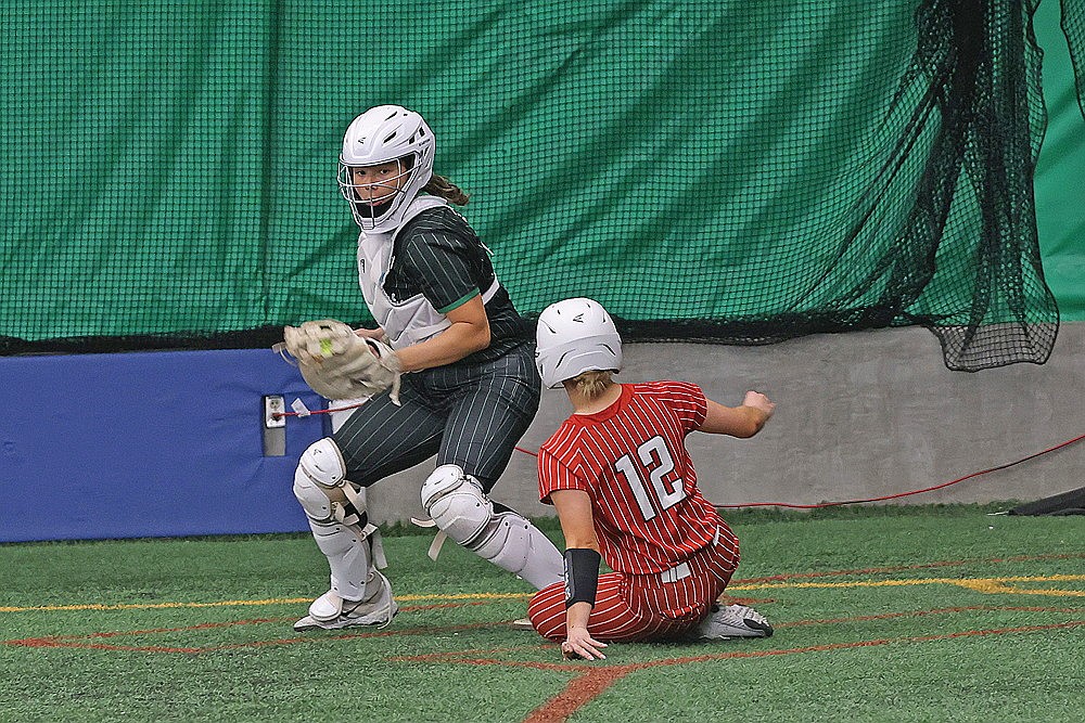 Medford’s Tori Nicks slides home in front of Rhinelander catcher Saige Mutter during a GNC softball game against Medford in the Hodag Dome Tuesday, April 28. (Blake Richard/River News)