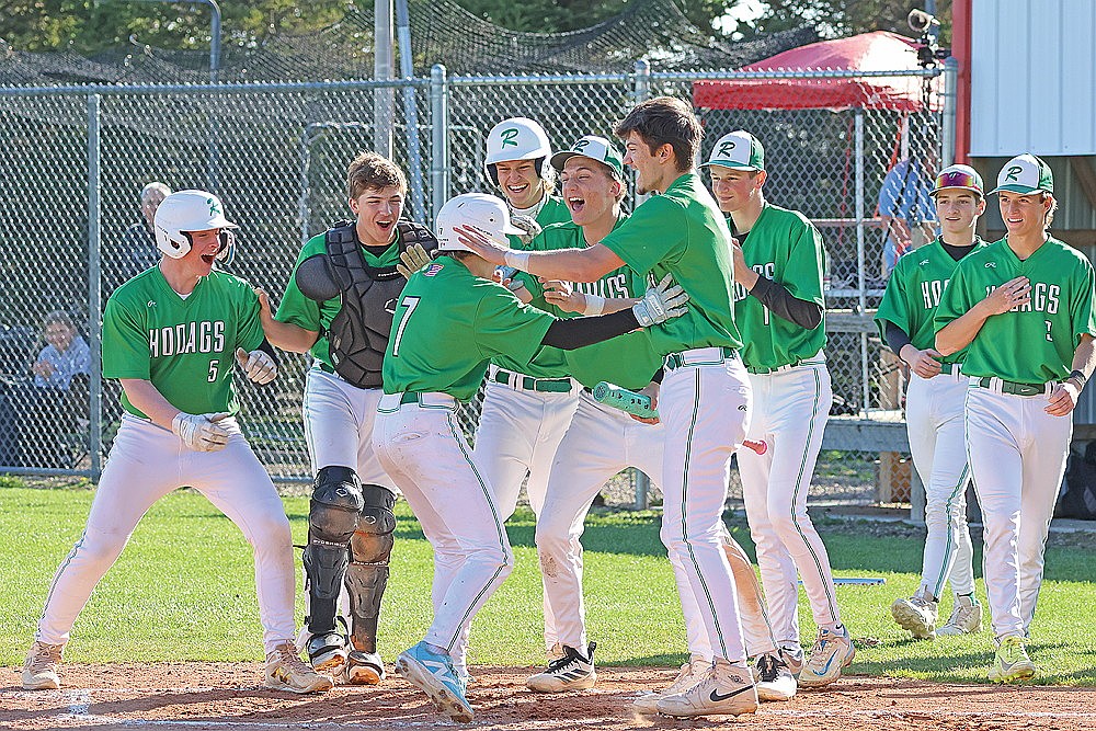 Members of the Rhinelander High School baseball team surround Weston Kibler (7) at home plate after Kibler hit a home run during the third inning of a GNC baseball game at Medford Tuesday, April 28. It was one of three home runs for the Hodags, who rallied from down 6-5 in the sixth to beat the Raiders, 10-6. (Matt Frey/Star News)