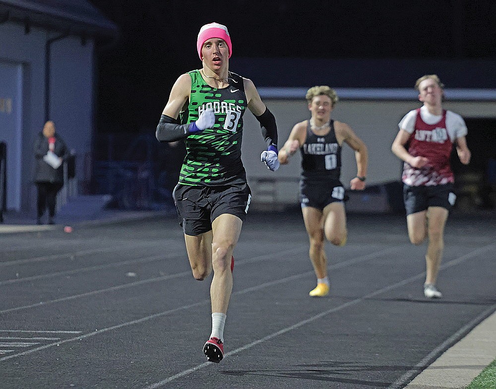 Rhinelander’s Avrom Barr pulls away from Lakeland’s Charlie Ernst (1) and lapped runner Shepard Snider of Antigo (10) in the final meters of the 3,200 meter run during the Lakeland Invite track meet in Minocqua Tuesday, May 5. (Jeremy Mayo/River News)