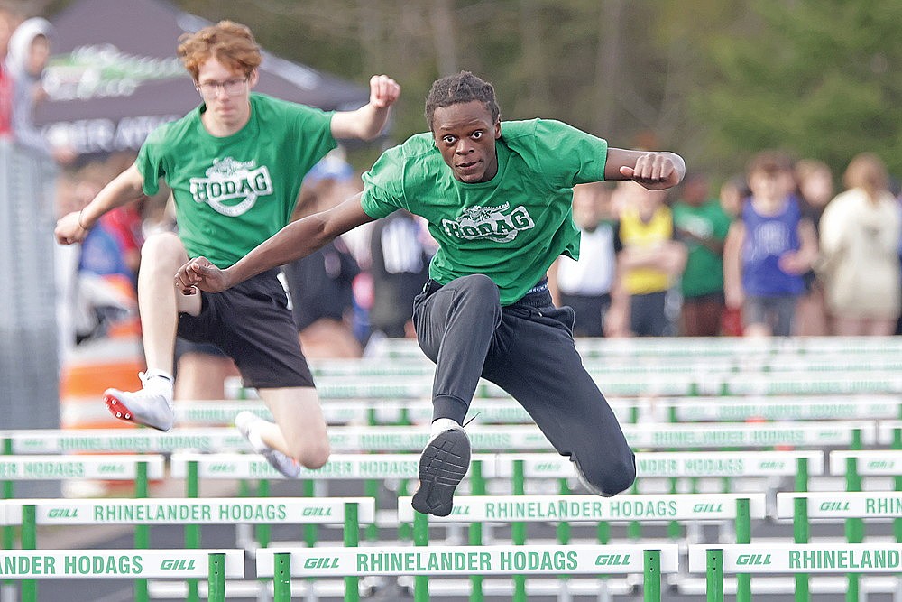 Belief Tulowitzky, foreground, and Mason Fawley compete in the 100-meter hurdles during a middle school track meet in Rhinelander Monday, May 4. (Jeremy Mayo/River News)
