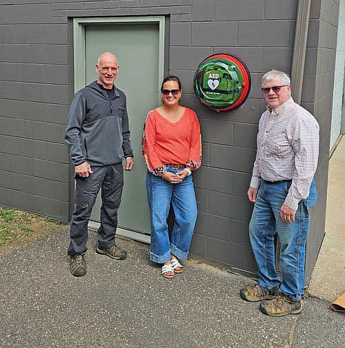 Minocqua fire chief Rich Carani, left, with Squirrel Lake Owners Association board member Rachel Eggebrecht and the association’s president, Glenn Isensee, at the Minocqua fire department’s Bo Di Lac Road station on Monday, May 4. (Contributed photograph)