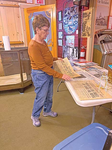 Marsha Doud, a volunteer for the Dr. Kate Museum in Woodruff, looks over newspapers that will be included in the museum’s exhibit for the 250th birthday of the United States that will debut during the museum’s open house on June 2. (Photo by Brian Jopek/Lakeland Times)