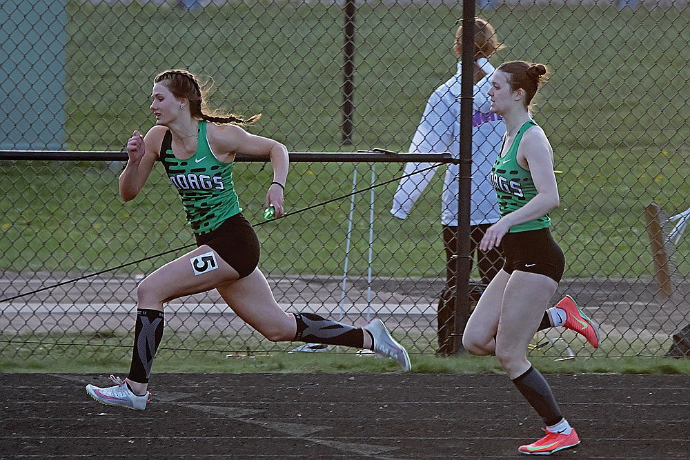 Rhinelander’s Violet Biolo, left, races with the baton after the exchange from teammate Olivia Ruetz, right, in the 4x100-meter relay during the Otto Bacher Invitational track meet in Merrill Friday, May 8. The Hodags won the event, one of six victories as they took first place overall in the 13-team meet. (Jeremy Mayo/River News)