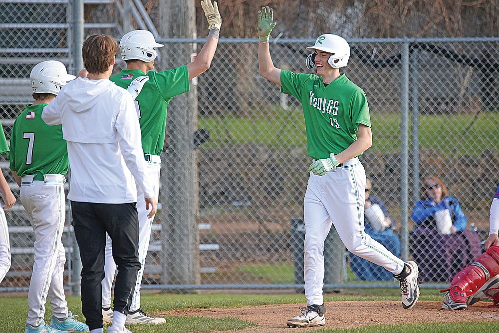 Rhinelander’s Vince White (13) celebrates his home run with teammates during a conference game against Merrill at Athletic Park in Merrill Monday, May 11. White was 1-for-3 in the contest, and also recorded 11 strikeouts as the Hodags’ starting pitcher. (Blake Richard/River News)