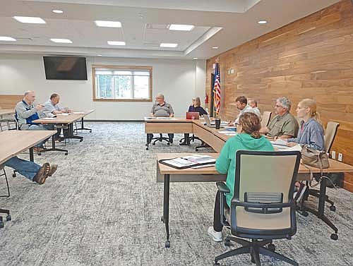 Town assessor Jef Muelver, far left, fills the Newbold town board in on the skyward market trend at their meeting Thursday, May 14. Listening beside him is Mark Fetzer and, from left around the table, Brad White, Petra Pietrzak, Mike McKenzie, Scott Ridderbusch, Dan Hess, Kim Gauthier and Jodie Hess. (Photo by Ardith Carlton/River News)