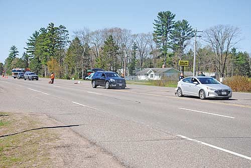 Law enforcement officers and Minocqua Fire Department personnel direct traffic as recovery crews prepare to remove a 2019 Hyundai Elantra and a 2013 GMC Acadia after a collision on U.S. Highway 51 on Minocqua’s south side Saturday, May 16. (Photo by Brian Jopek/Lakeland Times)