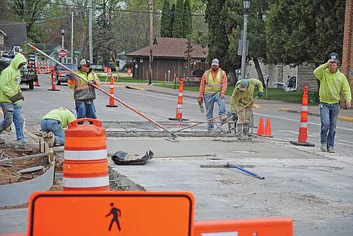 Workers with Chippewa Concrete Services smooth over freshly poured concrete in a section of a northbound lane of Chippewa Street (U.S. Highway 51) on May 19. (Photo by Brian Jopek/Lakeland Times)