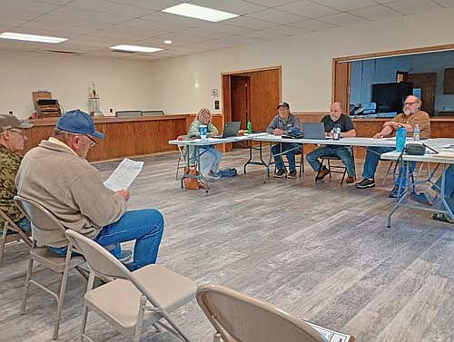 From left, Dave Brunette and Tom LaDue of Stella’s PFAS committee deliver an update to town clerk Stacy Schickert and the town board — supervisor Rich Hirman, chairman Casey Crump and supervisor Jerome Pokorny — May 11 at Stella Town Hall. (Photo by Ardith Carlton/River News)