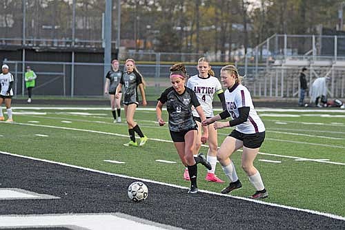 Bella Peterson looks to beat Antigo’s Ally Fuller (20) to the ball with Antigo’s Marie Fuller (4) looking on in the second half of a conference game Thursday, May 21 at IncredibleBank Field in Minocqua. (Photo by Brett LaBore/Lakeland Times)