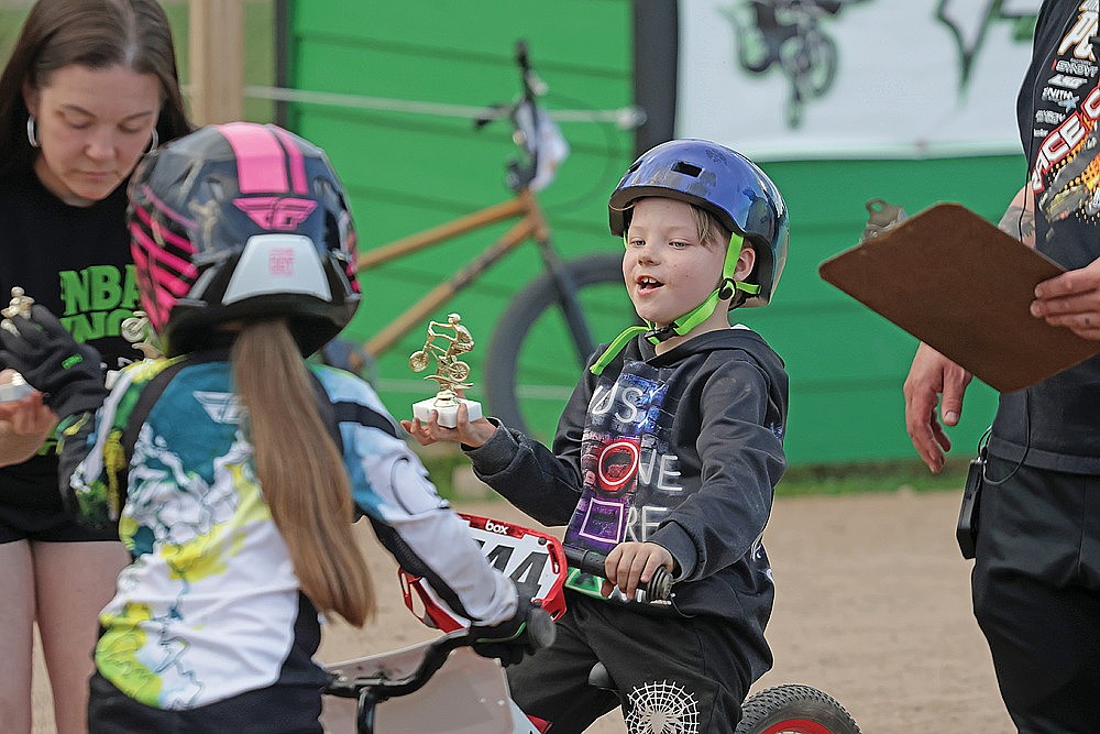Liam Friex shows off his trophy after taking first place in the 5 and over Balance Bike class.
