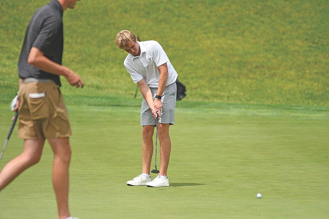 Davis Kock sinks a birdie putt on the eighth hole during round one of the WIAA Division 1 state meet Monday, June 8 at University Ridge in Madison. Kock shot a 1-under 71 following the first round. (Photo by Brett LaBore/Lakeland Times)