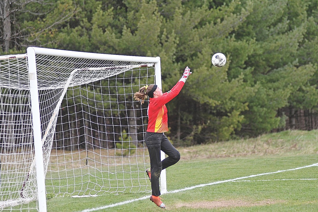 In this May 7, 2026 file photo, Ava Evenhouse goes to grab the ball for a save in a conference game against Northland Pines at Sam Larsen Memorial Field in Eagle River. Evenhouse was named the GNC defensive player of the year. (Photo by Brett LaBore/Lakeland Times)