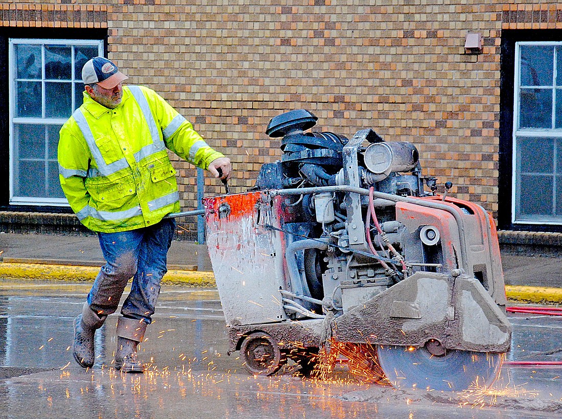An employee with Hard Rock Sawing and Drilling Specialists operates a concrete saw on northbound U.S. Highway 51 (Chippewa Street) between East Chicago and East Milwaukee streets in Minocqua on Wednesday, June 10. (Photo by Brian Jopek/Lakeland Times)