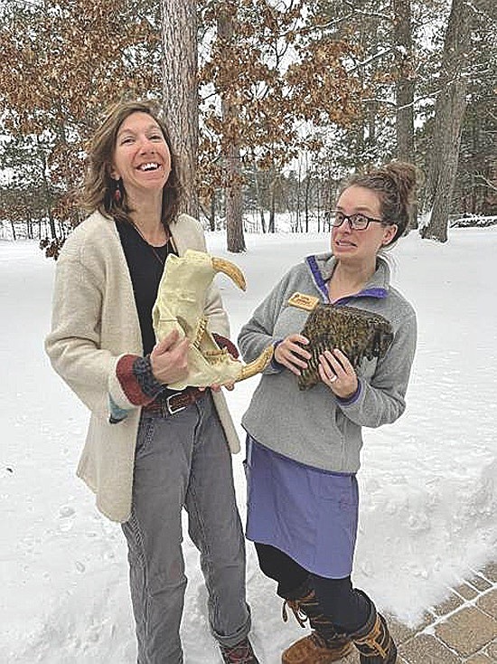 Jenna Richardson, left, holding a saber-tooth tiger skull, and Licia Kuckkahn Johnson holds a fossil they will both discuss during their presentation “Those Who Once Roamed - A Look at Prehistoric Animal Life” on June 17 at the St. Germain Community Center. (Contributed photograph)