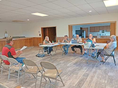 Hearing an update from Jeff Seamandel of MSA, left, at the June 9 Stella town board meeting are (l-r around the table) clerk Stacy Schickert, supervisors Rich Hirman, chairman Casey Crump and Jerome Pokorny, and treasurer Sara Zastrow. (Photo by Ardith Carlton/River News)