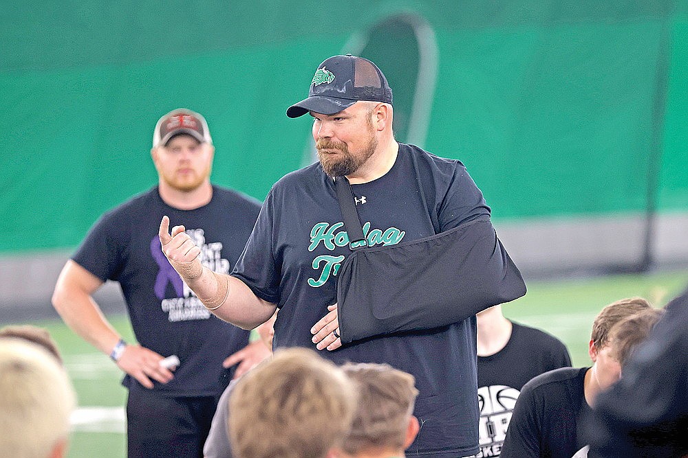 Rhinelander High School football coach Aaron Kraemer addresses his team during a contact day in the Hodag Dome Wednesday, June 10. It was the first contact day of the summer for the team. (Bob Mainhardt for the River News)