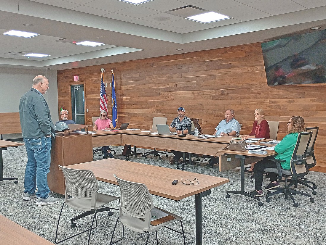 At the June 11 meeting of the Newbold town board, city assessor Jef Muelver (left) delivered his latest monthly report to, from left, town supervisors Brad White, Petra Pietrzak, Scott Ridderbusch and Mike McKenzie, clerk Kim Gauthier and treasurer Jodie Hess. (Photo by Ardith Carlton/River News)