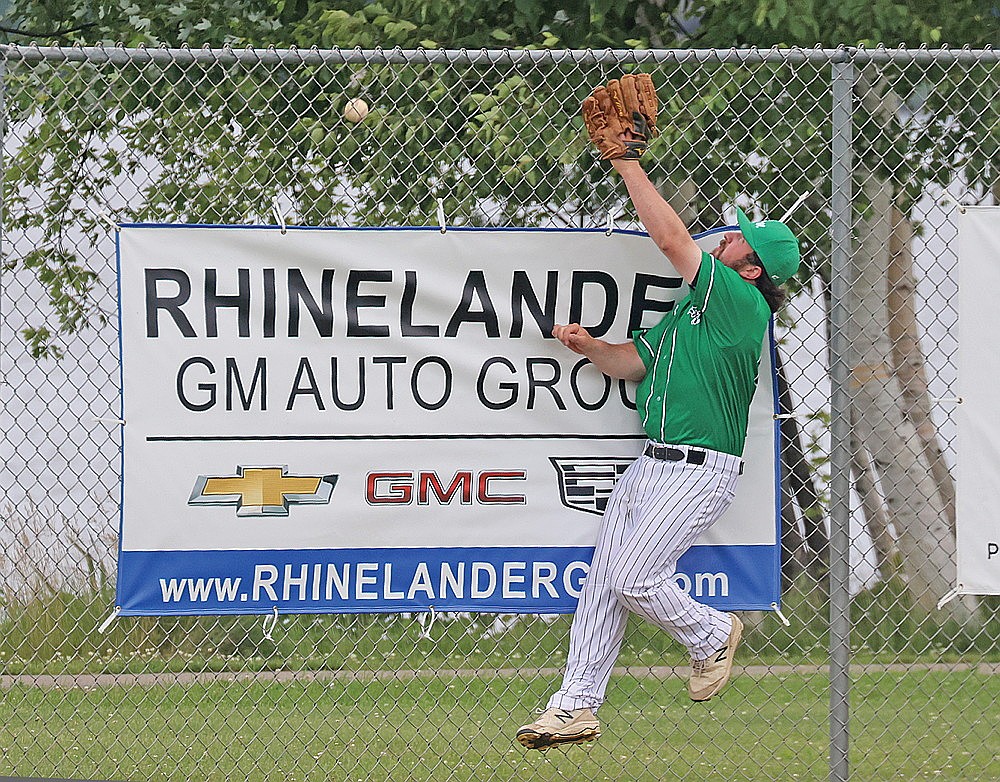 Rhinelander’s Brad Sowinski attempts to make a leaping catch on a home run ball by Abbotsford’s Tanner Hraby in the eighth inning of a Dairyland League baseball game at Stafford Field Sunday, June 28. Hraby had five RBIs, including a three-run double in the ninth, as Abbotsford rallied past Rhinelander, 7-6. (Bob Mainhardt for the River News)