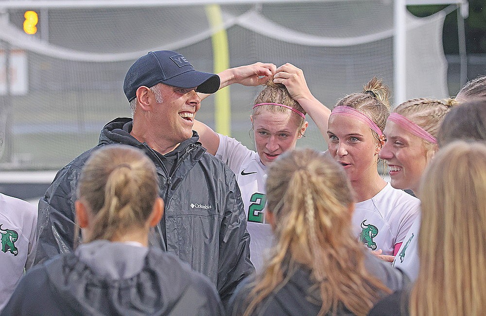 In this June 11, 2026 file photo, RHS girls’ soccer coach, Nathan Bates, smiles with his team after advancing to the sectional final. The team upset Lakeland 2-0 to make it to the sectional final for the first time since 2018. (Blake Richard/River News)