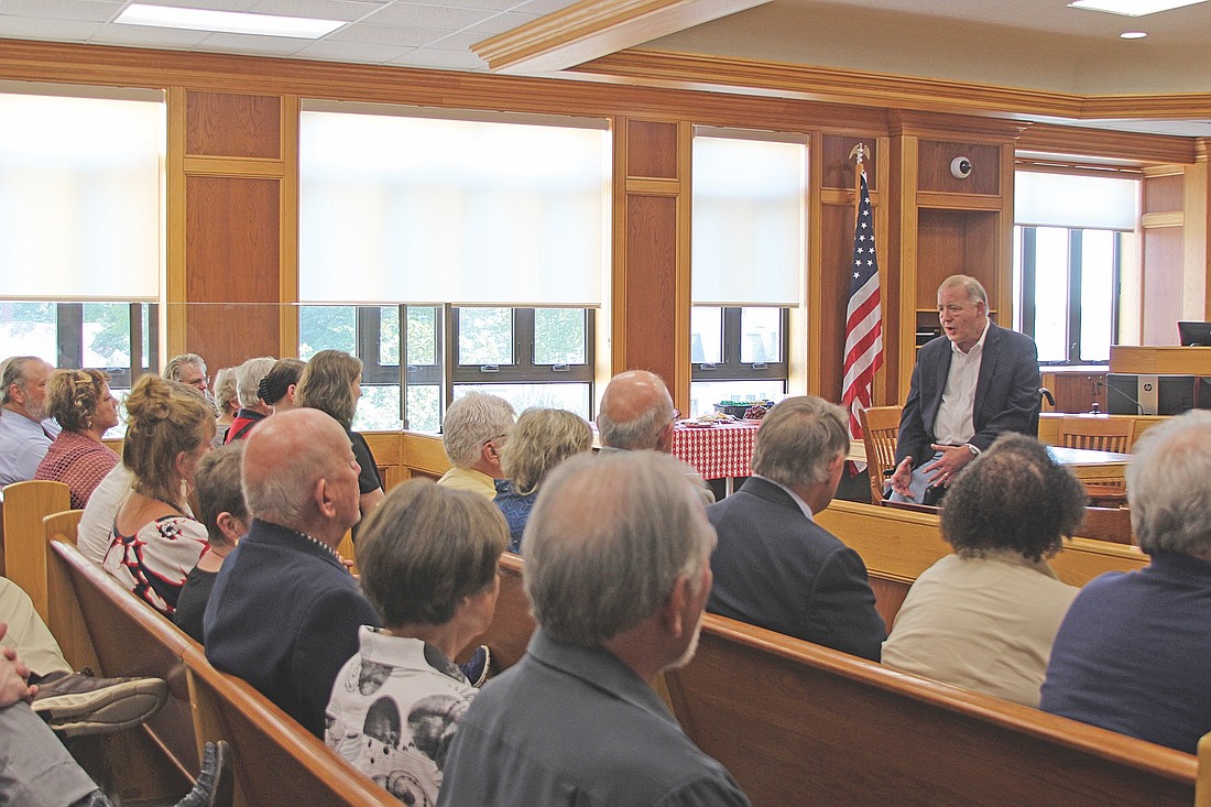 Wellwishers filled the Oneida County Circuit Court Branch II courtroom to hear retired Judge Michael Bloom (right) speak and witness the hanging of his portrait last Tuesday, July 1. (Photo by Ardith Carlton/River News)