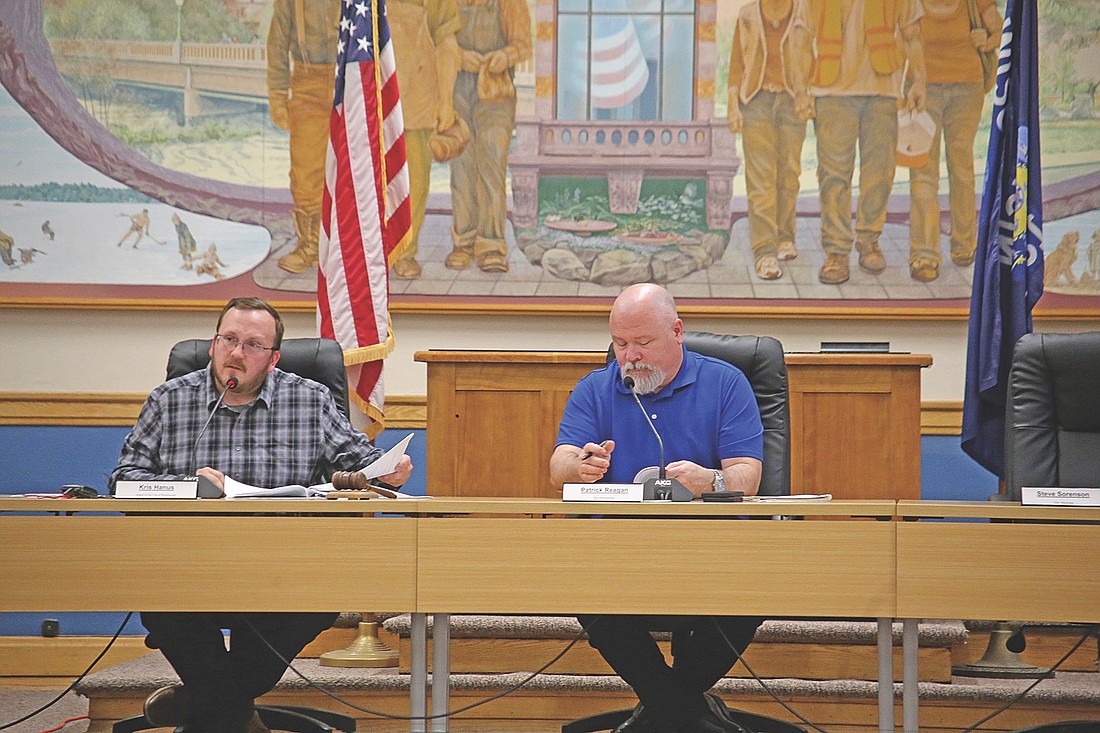 Rhinelander mayor Kris Hanus (left) and city administrator Patrick Reagan refer to the meeting packet during the July 1 Rhinelander Common Council special meeting. (Photo by Ardith Carlton/River News)