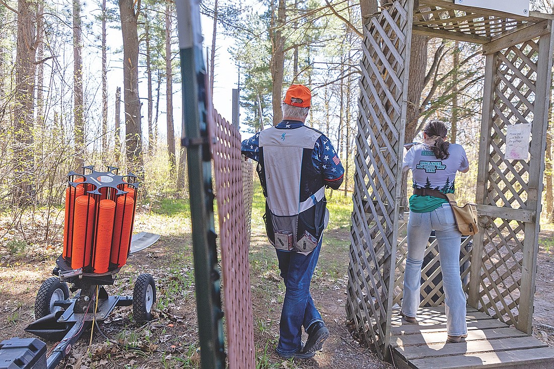 In this May 16, 2026 file photo, Rhinelander’s Lola Beach (right) takes aim on the sporting clay course as coach Chuck Garnier (left) watches during the Northwoods Invitational at the Harshaw Sports Club. Beach took first place in the senior/JV division for girls’ sporting clays at the invitational, and was awarded one of the RHS trap team’s High Gun awards for her marksmanship this season. (Photo by Blake Richard/River News)