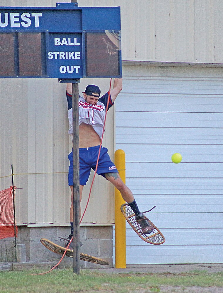 Snowhawks’ Jesse Robinson couldn’t quite haul in a scoreboard shot from the Chicago All-Stars during the July 4 game at Snowshoe Park in Lake Tomahawk. The hit gave the All-Stars a 6-4 lead, and they never looked back, defeating the Snowhawks 16-9. (Ardith Carlton/River News)