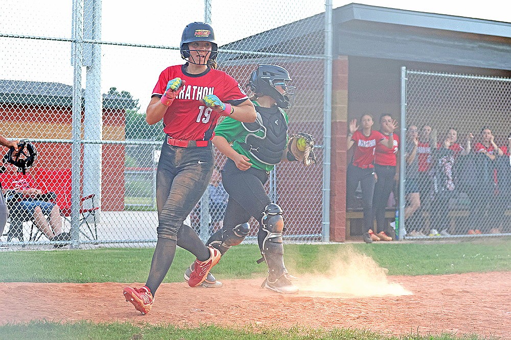Marathon’s Tyla Beilke-Seubert beats a throw to home plate caught by Rhinelander’s Amelia Berghammer to score the winning run in the seventh inning of an American Legion softball game in Marathon Tuesday, July 7. Rhinelander rallied from down 4-0 to tie the game, but lost on the walk-off play, 5-4. (Jeremy Mayo/River News)