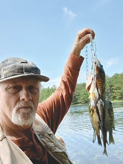 Dale Streubel holding a stringer of panfish he caught recently. (Contributed photograph)