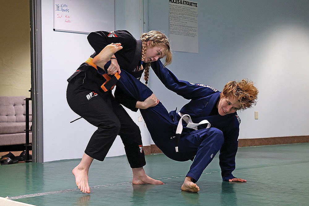 Saoirse Cichy, left, practices a move on Brazilian jiu jitsu partner, Nicole Peterson at Groundwork Grappling in Rhinelander on July 2. Earlier this summer, Cichy traveled to Lithuania as the youngest member on Team USA Federation of Pankration Athlima. After she returned to the United States, Cichy went to South Carolina to compete in the Global Association of Mixed Martial Arts (GAMMA) Youth National Tournament. (Blake Richard/River News)
