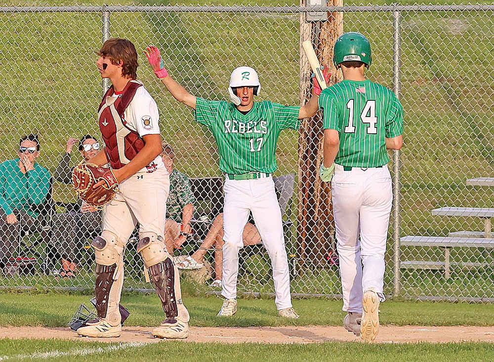 In this June 15, 2026 file photo, Rhinelander’s Hoyt Dantoin raises his hands and teammate Blake Bauer (14) scores a run during an American Legion baseball game against the Antigo Typhoon at Stafford Field. Rhinelander and Antigo join Superior and Niagara in a four-team Class AA regional tournament that kicks off Thursday at Stafford Field. (Bob Mainhardt for the River News)
