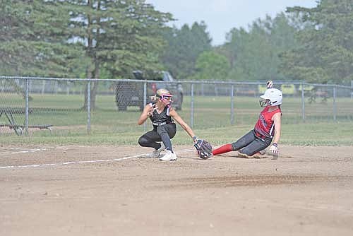 Katelyn Patterson attempts to tag out Medford’s McKenzie Frischmann at third base in the first inning of a 12U softball game during the Rod Timm Memorial Girls’ Fast Pitch Tournament Friday, July 17 at Sara Park in Tomahawk. (Photo by Brett LaBore/Lakeland Times)