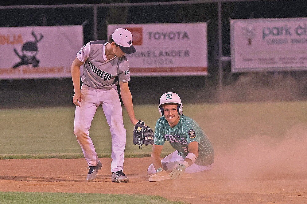 Rhinelander’s Abe Gretzinger looks back toward his dugout after stealing second base during the fifth inning of an American Legion baseball game against Minocqua at Stafford Field Monday, July 20. The Rebels defeated the 89ers, 11-4, in their regular season finale. (Bob Mainhardt for the River News)