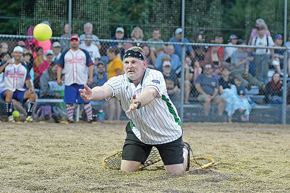 Benny Ives, Dazzle’s Demons, underhands the ball to first base for an out in the fifth inning of a snowshoe baseball game against the Snowhawks Monday, July 27 at Snowshoe Park in Lake Tomahawk. (Brett LaBore/Lakeland Times)