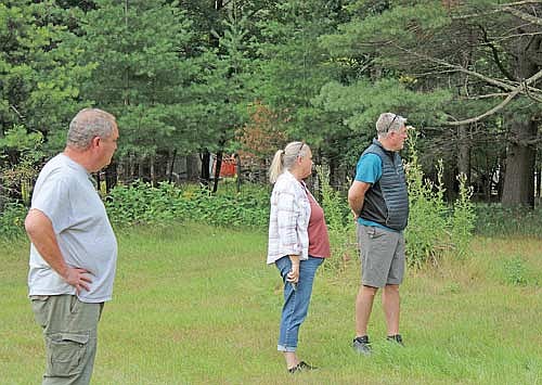 Matt Gaulke, left, Pam Carroll, middle, and Brandon Baker, right, observe the airport’s future property on North Farming Road during Tuesday night’s Lakeland Airport Commission meeting. (Photo by Jacob Link/Lakeland Times)