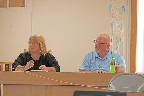 Lac du Flambeau board members Stephanie Greenway, left, and Dennis Pearson, right, listen to a public comment from Bill McCutchin about road repairs on West Lane during the town board meeting Wednesday night. (Photo by Jacob Link/Lakeland Times)