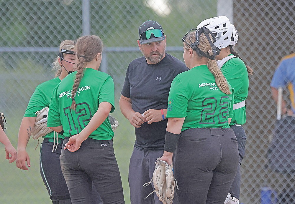 In this June 23, 2026 file photo, Rhinelander coach Zach Jordan meet with players Kadyn Taylor, Audrina Skubal (12), Brooke Rudis (22) and Saige Mutter during an American Legion softball game at Crandon. Rhinelander Post 7 went 3-4 this summer in its inaugural season of legion softball. (Jeremy Mayo/River News)